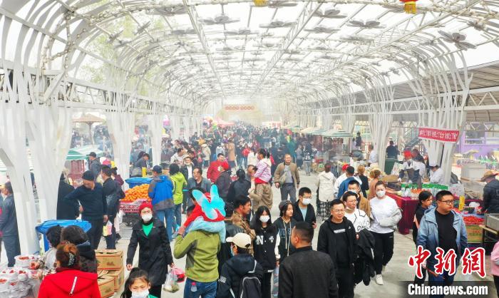 新疆库尔勒市梨花节开幕式上游客品味美食。 李洁 摄 新疆库尔勒市梨花节开幕式上游客品味美食。 李洁 摄